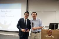 Prof. Huang Yu (right) presents a souvenir to Dr. Alex Chan